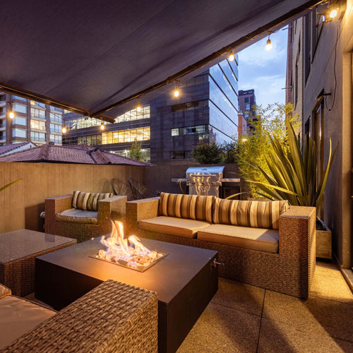 Gas fire table burning on a patio with lounge seating
