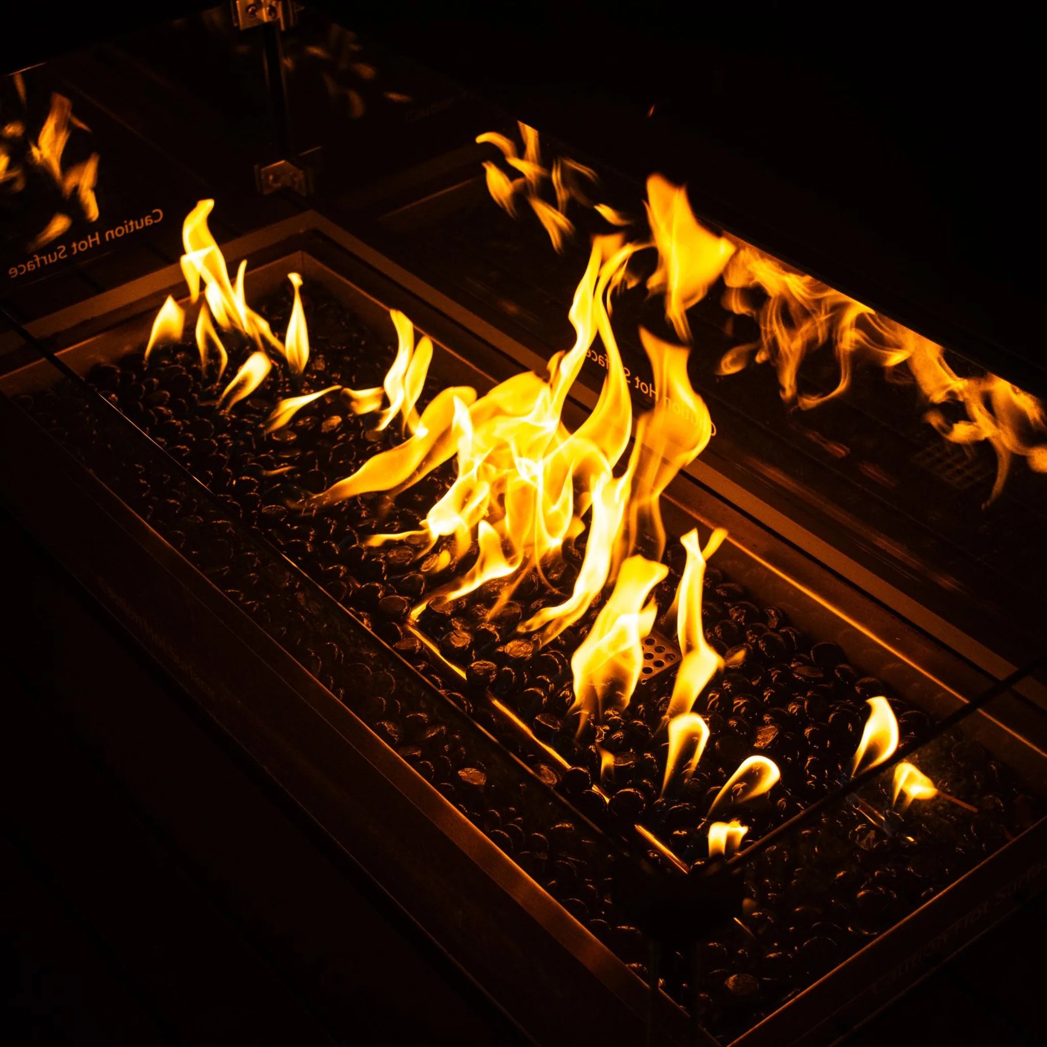 Rectangular gas burner with fire glass media at night