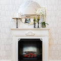 Built-in electric fireplace insert in a white mantel surround