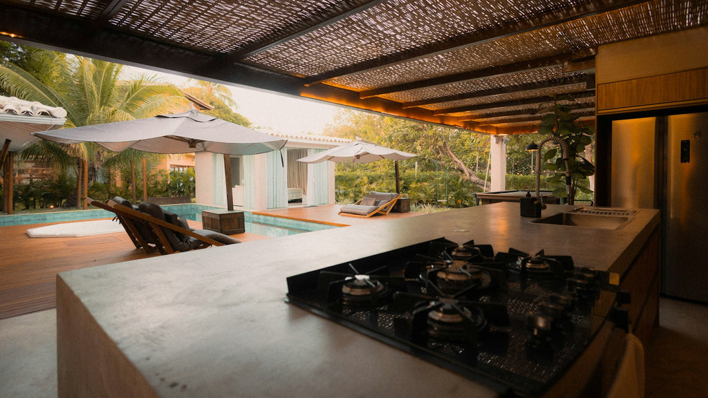Outdoor kitchen with built-in burners overlooking a pool